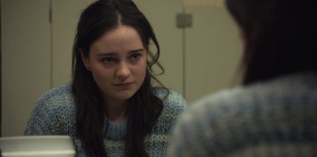 Movie still from “The Unforgivable” (2021), directed by Nora Fingscheidt – A woman sitting in front of a man in front of a mirror; Close Up shot, Over the shoulder angle