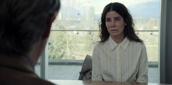 Movie still from “The Unforgivable” (2021), directed by Nora Fingscheidt – A woman sitting in front of a window looking sad; Close Up shot, Over the shoulder angle