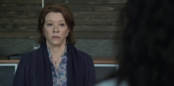 Movie still from “The Unforgivable” (2021), directed by Nora Fingscheidt – A woman in a blue jacket looking at the camera; Close Up shot, Over the shoulder angle