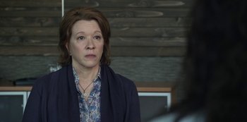 Movie still from “The Unforgivable” (2021), directed by Nora Fingscheidt – A woman in a blue shirt and a blue jacket; Close Up shot, Over the shoulder angle