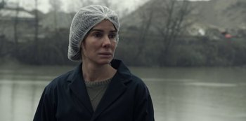 Movie still from “The Unforgivable” (2021), directed by Nora Fingscheidt – A woman wearing a white hat and a black coat; Close Up shot, Over the shoulder angle