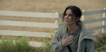 Movie still from “The Unforgivable” (2021), directed by Nora Fingscheidt – A woman with her hands over her heart; Close Up shot, Over the shoulder angle