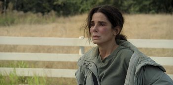 Movie still from “The Unforgivable” (2021), directed by Nora Fingscheidt – A woman sitting on a bench with her eyes wide open; Close Up shot, High angle