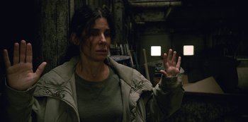 Movie still from “The Unforgivable” (2021), directed by Nora Fingscheidt – A woman is holding her hand up in the air; Medium shot, High angle