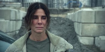 Movie still from “The Unforgivable” (2021), directed by Nora Fingscheidt – A person wearing a jacket near a wall; Close Up shot, High angle