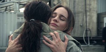 Movie still from “The Unforgivable” (2021), directed by Nora Fingscheidt – Two women are hugging each other in a city; Close Up shot, Over the shoulder angle