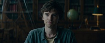 Movie still from “The Vault” (2021), directed by Jaume Balagueró – A person wearing a green shirt; Close Up shot, Over the shoulder angle
