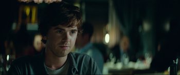 Movie still from “The Vault” (2021), directed by Jaume Balagueró – A young man is looking into the distance; Close Up shot, Over the shoulder angle