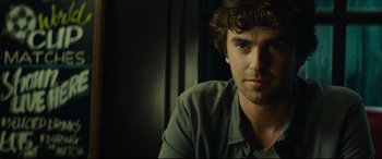 Movie still from “The Vault” (2021), directed by Jaume Balagueró – A person sitting in front of a window; Close Up shot, Over the shoulder angle