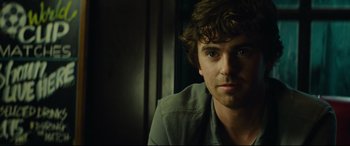 Movie still from “The Vault” (2021), directed by Jaume Balagueró – A person wearing a green shirt; Close Up shot, Over the shoulder angle