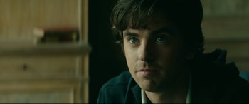 Movie still from “The Vault” (2021), directed by Jaume Balagueró – A person with green eyes; Close Up shot, Over the shoulder angle