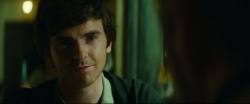 Movie still from “The Vault” (2021), directed by Jaume Balagueró – A man's face in a green shirt; Close Up shot, Over the shoulder angle