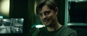 Movie still from “The Vault” (2021), directed by Jaume Balagueró – A person with a beard; Close Up shot, Over the shoulder angle