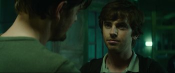 Movie still from “The Vault” (2021), directed by Jaume Balagueró – A man looking at himself in the mirror; Close Up shot, Over the shoulder angle