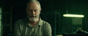 Movie still from “The Vault” (2021), directed by Jaume Balagueró – An older man with a white beard is looking into the distance; Close Up shot, Low angle