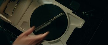 Movie still from “The Vault” (2021), directed by Jaume Balagueró – A person using a record player to record a song; Extreme Close Up shot, Overhead angle
