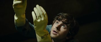 Movie still from “The Vault” (2021), directed by Jaume Balagueró – A person wearing a yellow rubber glove; Close Up shot, Overhead angle