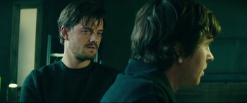 Movie still from “The Vault” (2021), directed by Jaume Balagueró – A man looking at himself in the mirror; Close Up shot, Over the shoulder angle