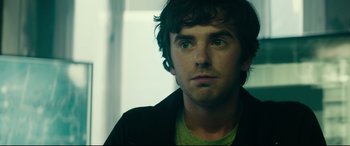 Movie still from “The Vault” (2021), directed by Jaume Balagueró – A person wearing a green shirt; Close Up shot, Over the shoulder angle