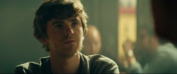 Movie still from “The Vault” (2021), directed by Jaume Balagueró – A person wearing a jacket; Close Up shot, Over the shoulder angle