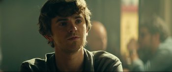 Movie still from “The Vault” (2021), directed by Jaume Balagueró – A person wearing a shirt; Close Up shot, Over the shoulder angle