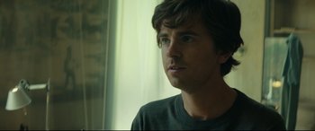 Movie still from “The Vault” (2021), directed by Jaume Balagueró – A person looking at the camera; Close Up shot, Over the shoulder angle