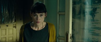 Movie still from “The Vault” (2021), directed by Jaume Balagueró – A young woman standing in front of a door; Close Up shot, Over the shoulder angle
