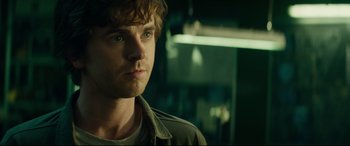 Movie still from “The Vault” (2021), directed by Jaume Balagueró – A person wearing a jacket; Close Up shot, Over the shoulder angle