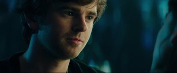 Movie still from “The Vault” (2021), directed by Jaume Balagueró – A young man's face in the dark; Close Up shot, Over the shoulder angle