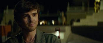 Movie still from “The Vault” (2021), directed by Jaume Balagueró – A person smiling for the camera; Close Up shot, Over the shoulder angle