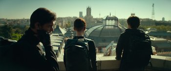 Movie still from “The Vault” (2021), directed by Jaume Balagueró – A group of people standing next to each other on top of a building; Medium shot, Low angle