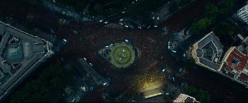 Movie still from “The Vault” (2021), directed by Jaume Balagueró – An aerial view of a crowd of people in a park; Extreme Wide shot, Overhead angle