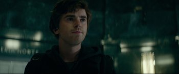 Movie still from “The Vault” (2021), directed by Jaume Balagueró – A young man is looking into the distance; Close Up shot, Over the shoulder angle