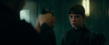 Movie still from “The Vault” (2021), directed by Jaume Balagueró – A young woman standing in front of a man; Close Up shot, Over the shoulder angle