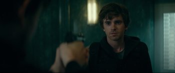 Movie still from “The Vault” (2021), directed by Jaume Balagueró – A man holding a gun in front of a mirror; Close Up shot, Over the shoulder angle