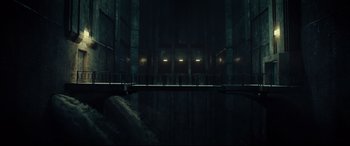 Movie still from “The Vault” (2021), directed by Jaume Balagueró – A dark room with lights on the walls; Extreme Wide shot, Low angle