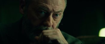 Movie still from “The Vault” (2021), directed by Jaume Balagueró – An old man with a beard and a piercing in his ear; Close Up shot, Low angle