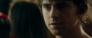 Movie still from “The Vault” (2021), directed by Jaume Balagueró – A person's face in a dark room; Extreme Close Up shot, Over the shoulder angle