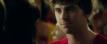 Movie still from “The Vault” (2021), directed by Jaume Balagueró – A person wearing a red shirt; Close Up shot, Over the shoulder angle