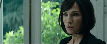 Movie still from “The Vault” (2021), directed by Jaume Balagueró – A person with short black hair; Close Up shot, Over the shoulder angle