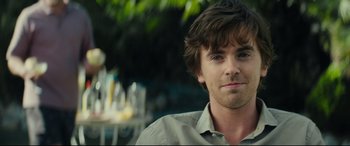 Movie still from “The Vault” (2021), directed by Jaume Balagueró – A person wearing a dress shirt; Close Up shot, Over the shoulder angle