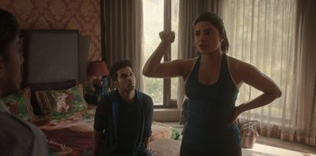 Movie still from “The White Tiger” (2021), directed by Ramin Bahrani – A man and a woman are standing in a room; Medium shot, Over the shoulder angle