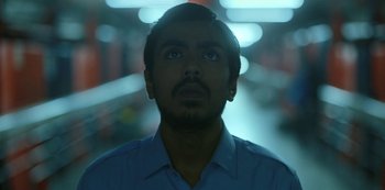 Movie still from “The White Tiger” (2021), directed by Ramin Bahrani – A person looking up at the sky; Close Up shot, Low angle