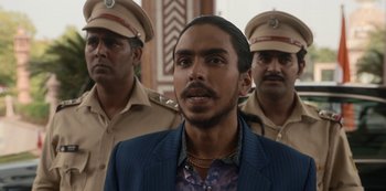 Movie still from “The White Tiger” (2021), directed by Ramin Bahrani – A group of men in uniform standing next to each other; Close Up shot, Low angle