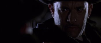 Movie still from “Road to Perdition” (2002), directed by Sam Mendes – A person wearing a hat; Close Up shot, Over the shoulder angle