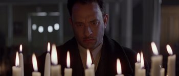 Movie still from “Road to Perdition” (2002), directed by Sam Mendes – A man that is looking at the candles; Close Up shot, Low angle