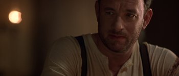 Movie still from “Road to Perdition” (2002), directed by Sam Mendes – A person wearing a white shirt; Close Up shot, Over the shoulder angle