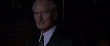Movie still from “Road to Perdition” (2002), directed by Sam Mendes – An older man wearing a suit and tie; Close Up shot, Low angle