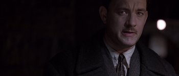 Movie still from “Road to Perdition” (2002), directed by Sam Mendes – A man in a suit and a tie; Close Up shot, Over the shoulder angle
