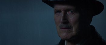 Movie still from “Road to Perdition” (2002), directed by Sam Mendes – An old man wearing a hat and a suit; Close Up shot, Low angle